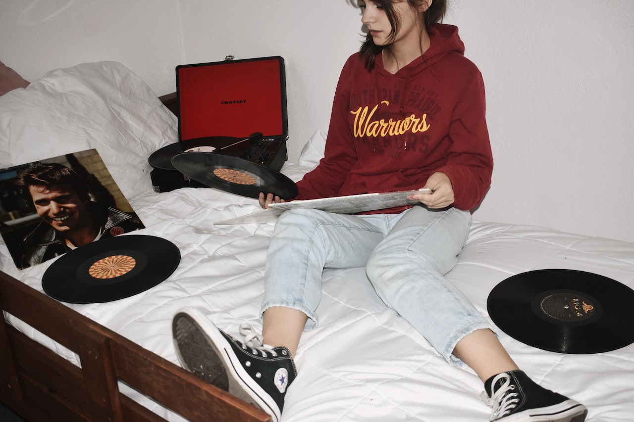 Woman is wondering how to use vinyl record player
